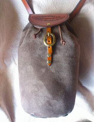Handmade leather bag by Ancestor Leathercrafts. Hand tooled, hand dyed flap, leather strap, brass fittings, hand sewn leather body. steampunk buy now online