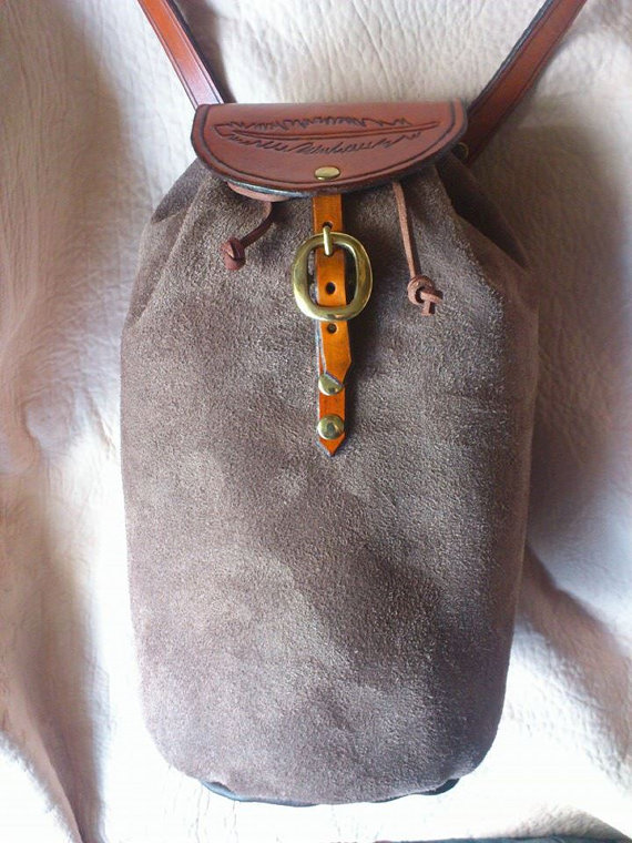 Handmade leather bag by Ancestor Leathercrafts. Hand tooled, hand dyed flap, leather strap, brass fittings, hand sewn leather body. steampunk buy now online