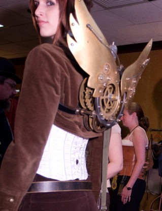 Corset and clockwork wings on a steampunk girl at Steampunk Worlds Fair steampunk buy now online