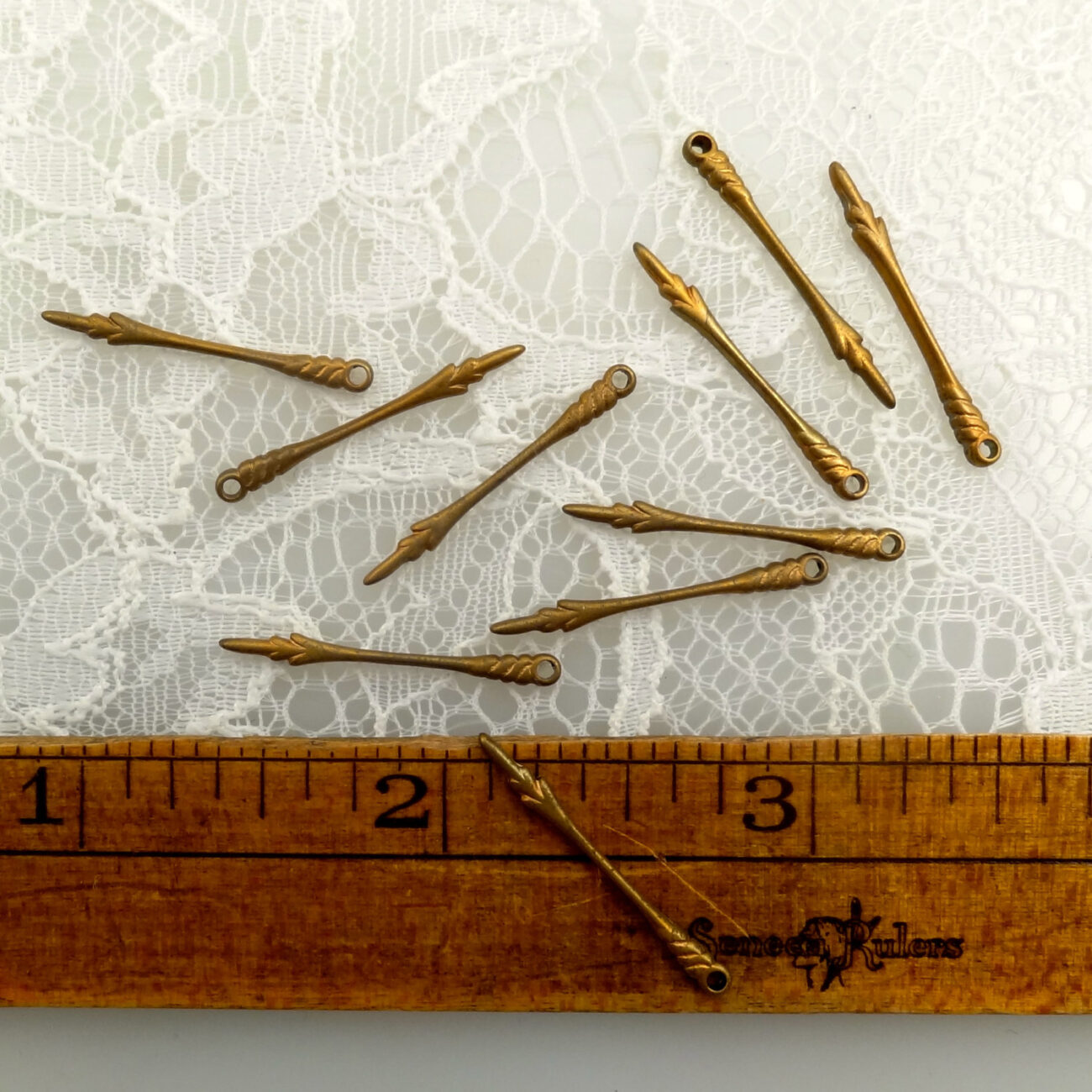 10 Brass stampings watch hands or elongated Fleur de lis with hole flat backed steampunk buy now online