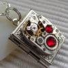 Steampunk book locket necklace with vintage watch movement and Ruby Red Swarovski crystals steampunk buy now online