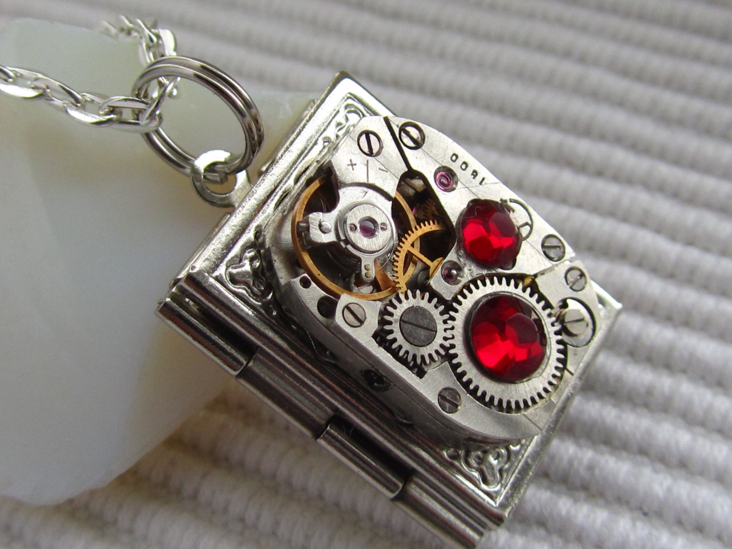 Steampunk book locket necklace with vintage watch movement and Ruby Red Swarovski crystals steampunk buy now online
