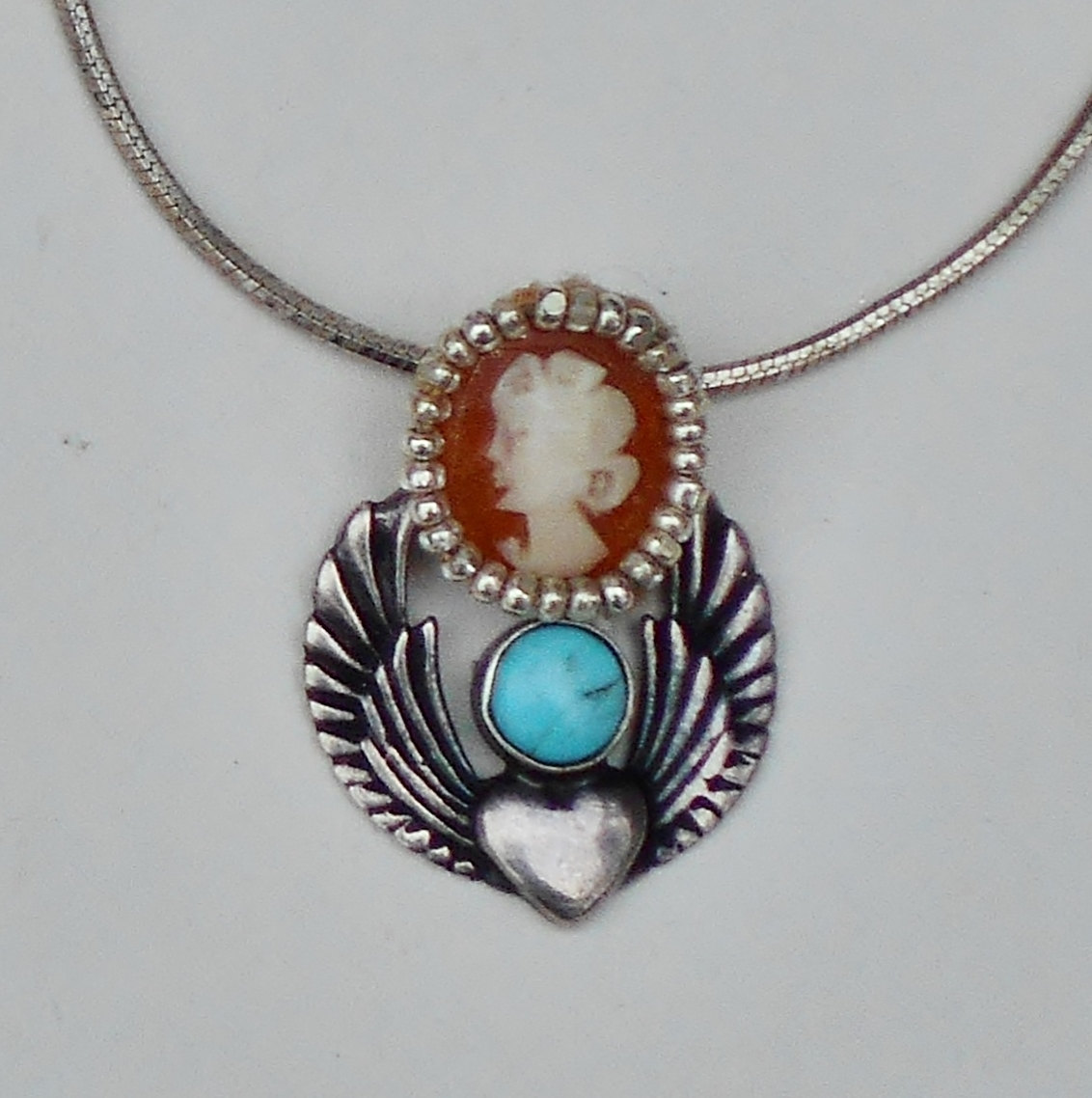 Steampunk Art Nouveau Heart with Turquoise, Hand Carved 1/2" Shell Cameo on Sterling Silver Heart with Wings Sterling Snake Necklace. steampunk buy now online