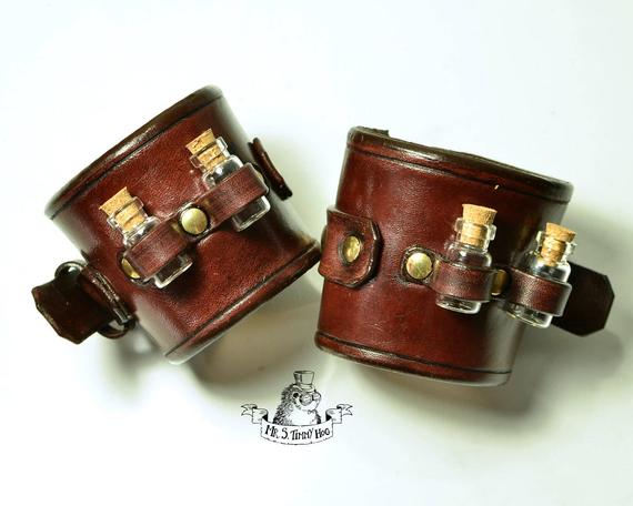 A pair of bracelets with little bottles by TimmyHog steampunk buy now online