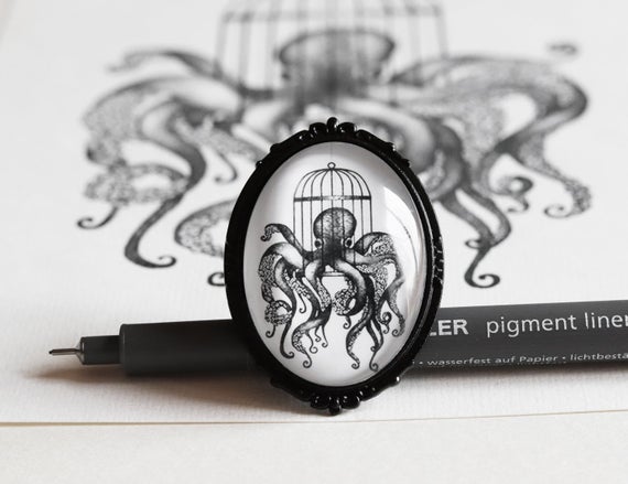 Brooch with octopus in a birdcage drawing - handmade jewel created with printed illustration by Saraelanillustration steampunk buy now online