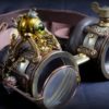 Steampunk goggles in dark brown leather and brass with folding lens, little decorative automaton, decorative gears and embossed decoration by TheTimeCabinet steampunk buy now online