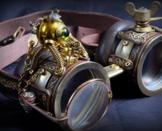 Steampunk goggles in dark brown leather and brass with folding lens, little decorative automaton, decorative gears and embossed decoration by TheTimeCabinet steampunk buy now online