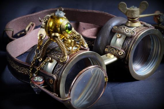 Steampunk goggles in dark brown leather and brass with folding lens, little decorative automaton, decorative gears and embossed decoration by TheTimeCabinet steampunk buy now online