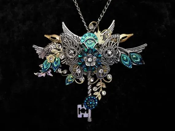 Beautiful Steampunk Vintage-style "Key to my Heart" necklace in blue green silver and gold + silver filigree butterfly, key, & crystals by KindHeartsEmporium steampunk buy now online Beautiful Steampunk Vintage-style "Key to my Heart" necklace in blue green silver and gold + silver filigree butterfly, key, & crystals by KindHeartsEmporium steampunk buy now online