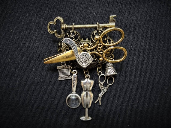 Charming Vintage-style Steampunk Seamstress Chatelaine pin brooch in bronze, gold and silver featuring gorgeous dressmaking charms by KindHeartsEmporium steampunk buy now online