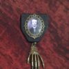 Poe's Eerie Touch: Edgar Allan Poe Medal set in hand-cast resin in Vintage-style Filigree Bronze frame with Bronze Skeletal Hand by TorchandArrow steampunk buy now online
