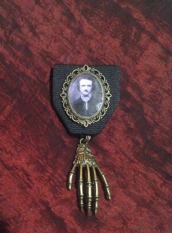 Poe's Eerie Touch: Edgar Allan Poe Medal set in hand-cast resin in Vintage-style Filigree Bronze frame with Bronze Skeletal Hand by TorchandArrow steampunk buy now online